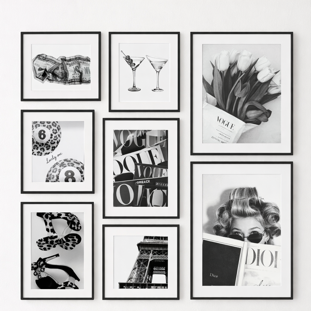 Collection of black and white framed artworks on a wall