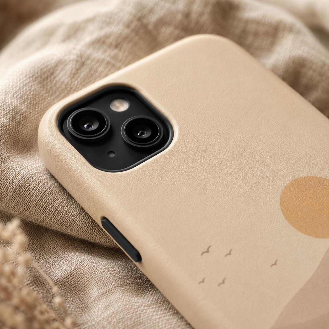 Beige phone case with a subtle pattern on a textured fabric background