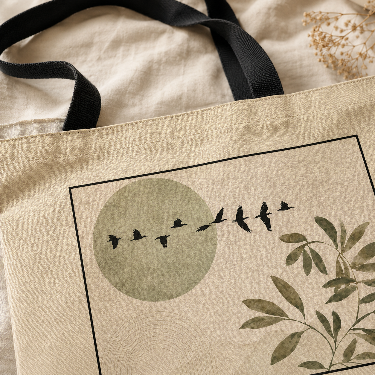Beige tote bag with nature-themed design featuring birds and leaves.