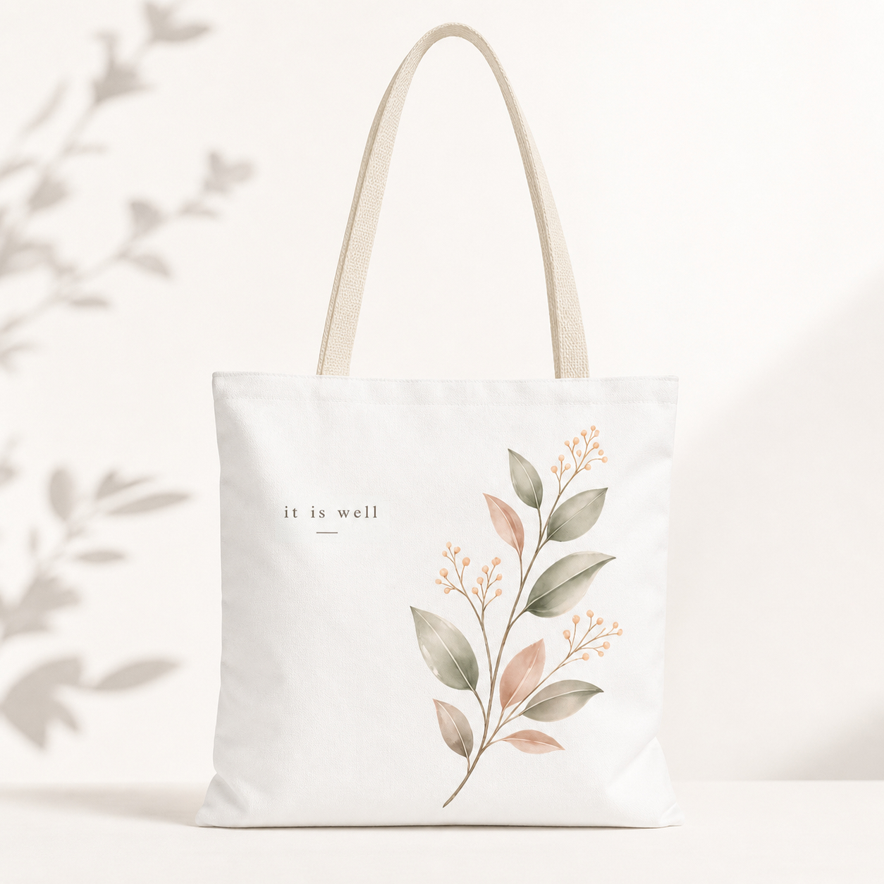 Tote bag with floral design and 'it is well' text on a white background
